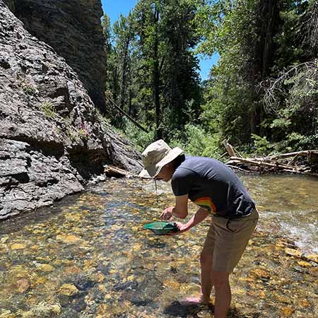 Me gold panning in a very cold river